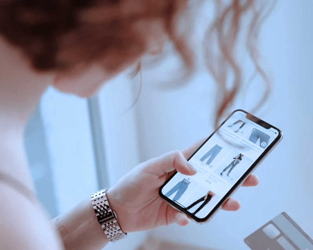 woman shopping for jeans on her mobile phone